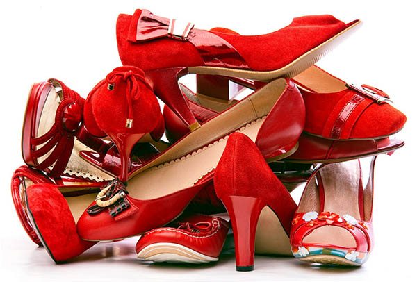 Pile of female red shoes isolated on white background
