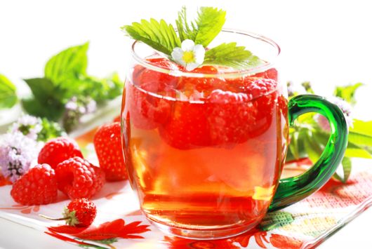 Refreshing summer ice tea with fruits and herbs